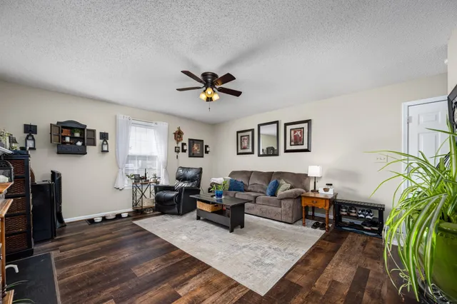 a living room with furniture and wooden floor