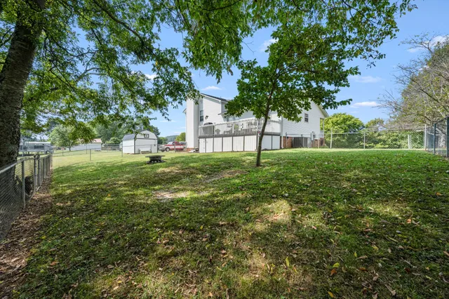an aerial view of a house with a yard and lake view