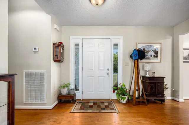 a living room with furniture gym equipment and a window