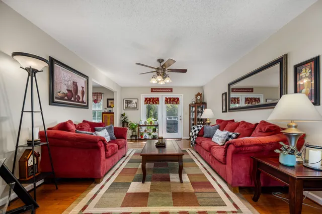 a living room with furniture a rug and a chandelier