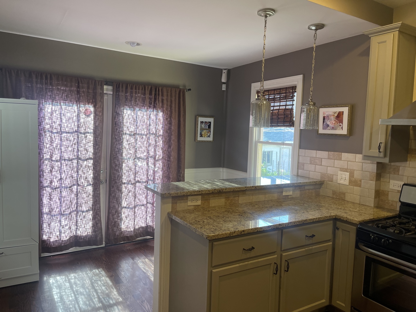 4106 North Drake Avenue Chicago, IL 60618 - Photo 3 of 18 a kitchen with granite countertop a sink a stove and wooden floor