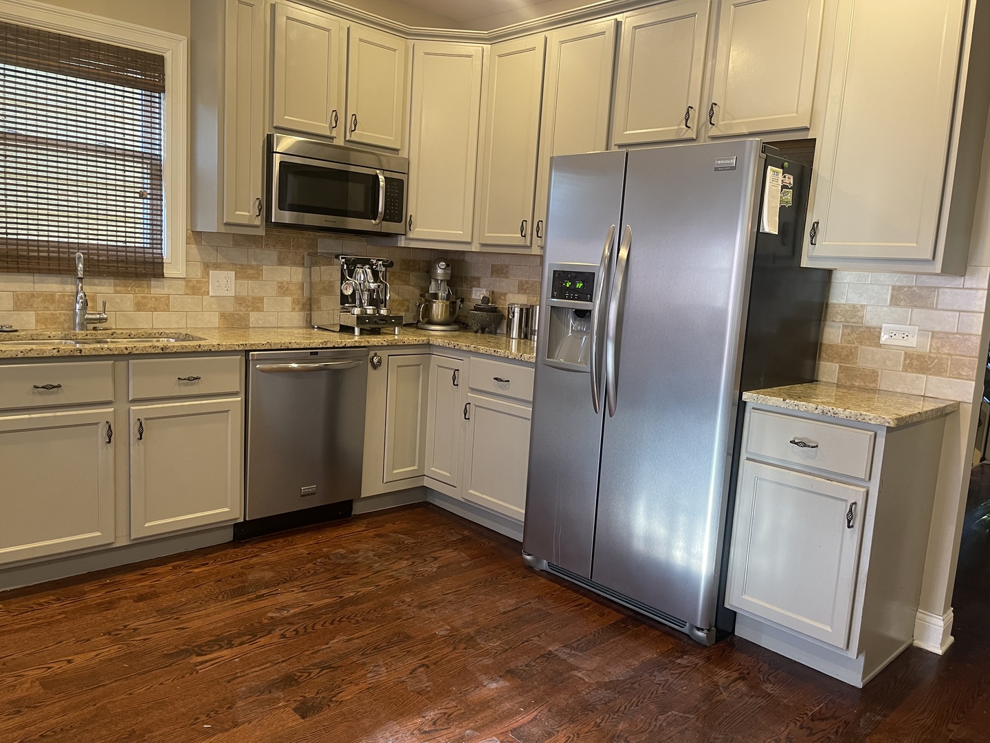 4106 North Drake Avenue Chicago, IL 60618 - Photo 7 of 18 a kitchen with stainless steel appliances granite countertop a refrigerator stove a sink and dishwasher with wooden floor