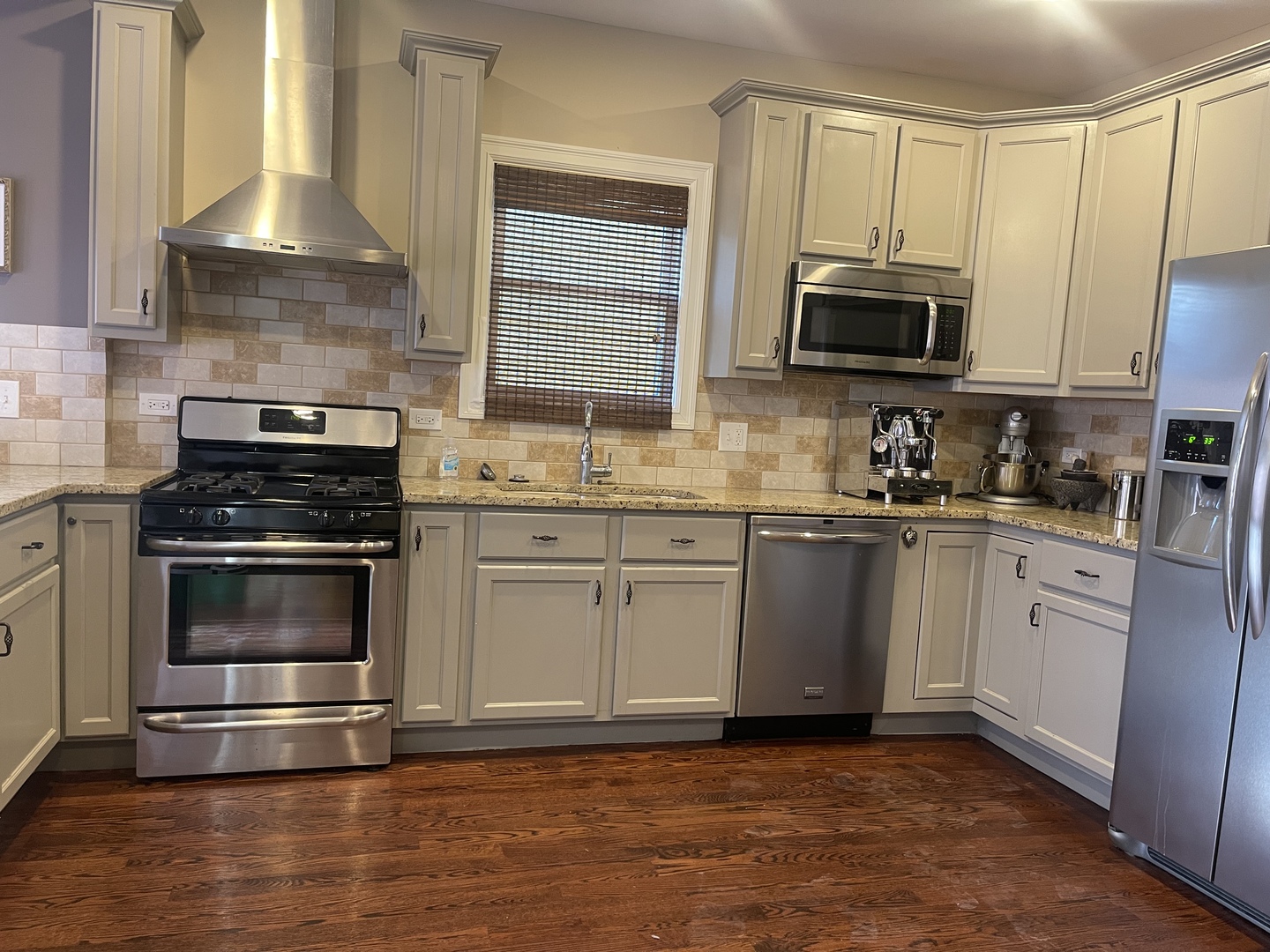 4106 North Drake Avenue Chicago, IL 60618 - Photo 8 of 18 a kitchen with stainless steel appliances a stove a sink and a microwave