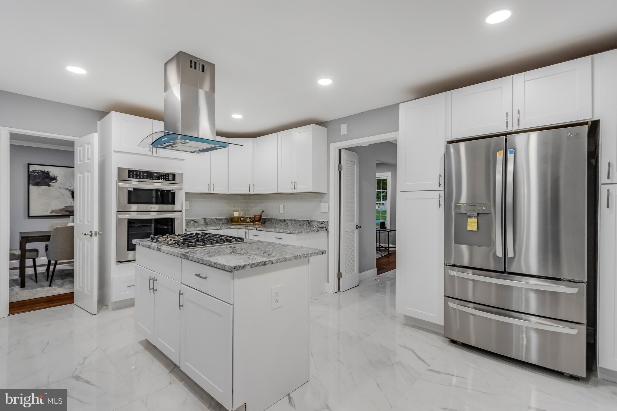 11208 Old Post Road Potomac, MD 20854 - Photo 8 of 52 a kitchen with stainless steel appliances granite countertop a refrigerator and a stove top oven
