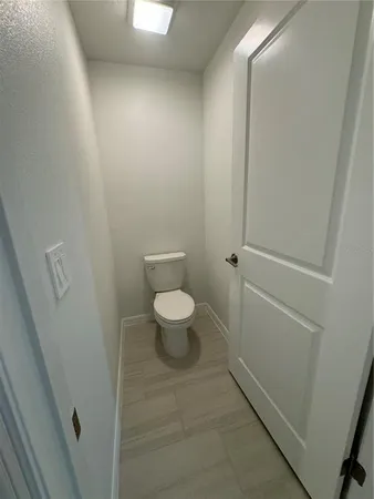 a bathroom with a toilet and a mirror