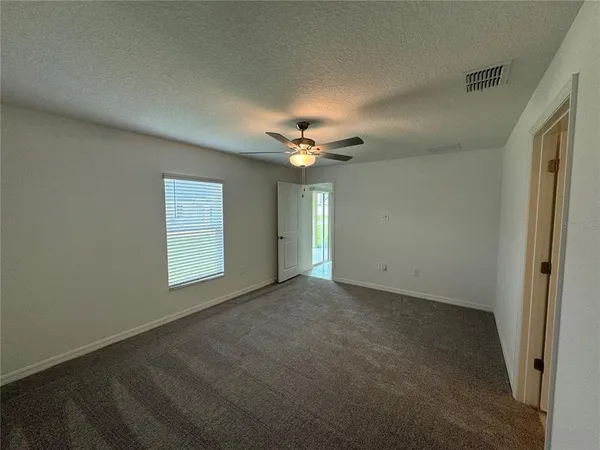a view of a livingroom with a ceiling fan and window