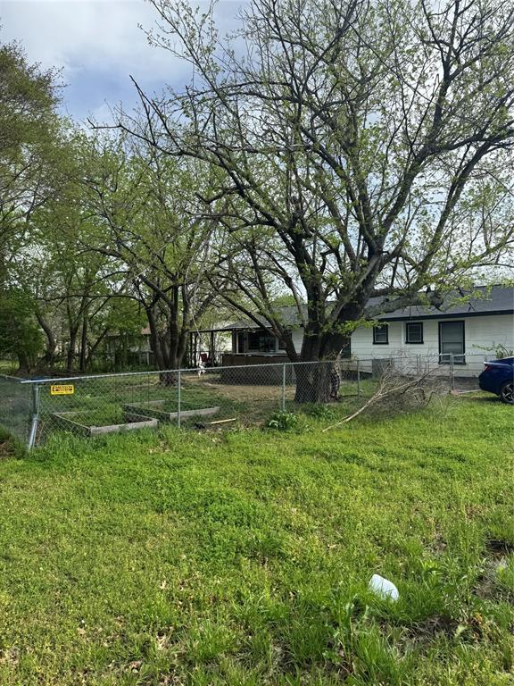 1020 Southeast 10th Street Cooper, TX 75432 - Photo 2 of 11 a view of backyard with table and chairs and large trees