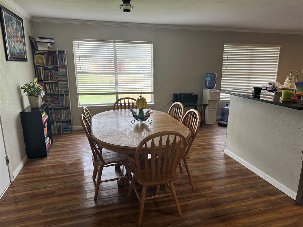 1020 Southeast 10th Street Cooper, TX 75432 - Photo 9 of 11 a view of a dining room with furniture window and wooden floor