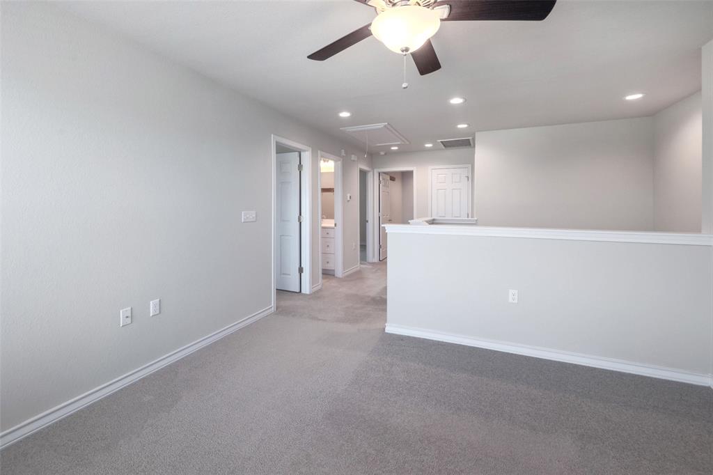 2004 Rinker Ranch Drive Austin, TX 78725 - Photo 12 of 23 an empty room with a kitchen and a chandelier fan