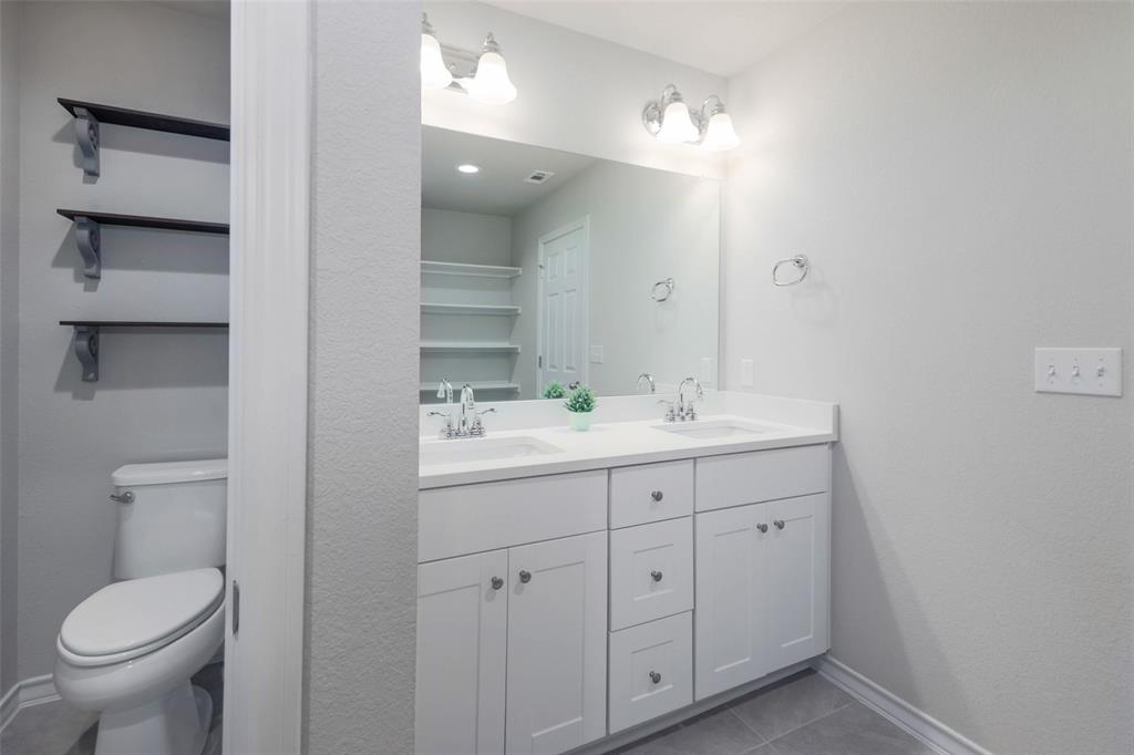 2004 Rinker Ranch Drive Austin, TX 78725 - Photo 14 of 23 a bathroom with a toilet sink and mirror