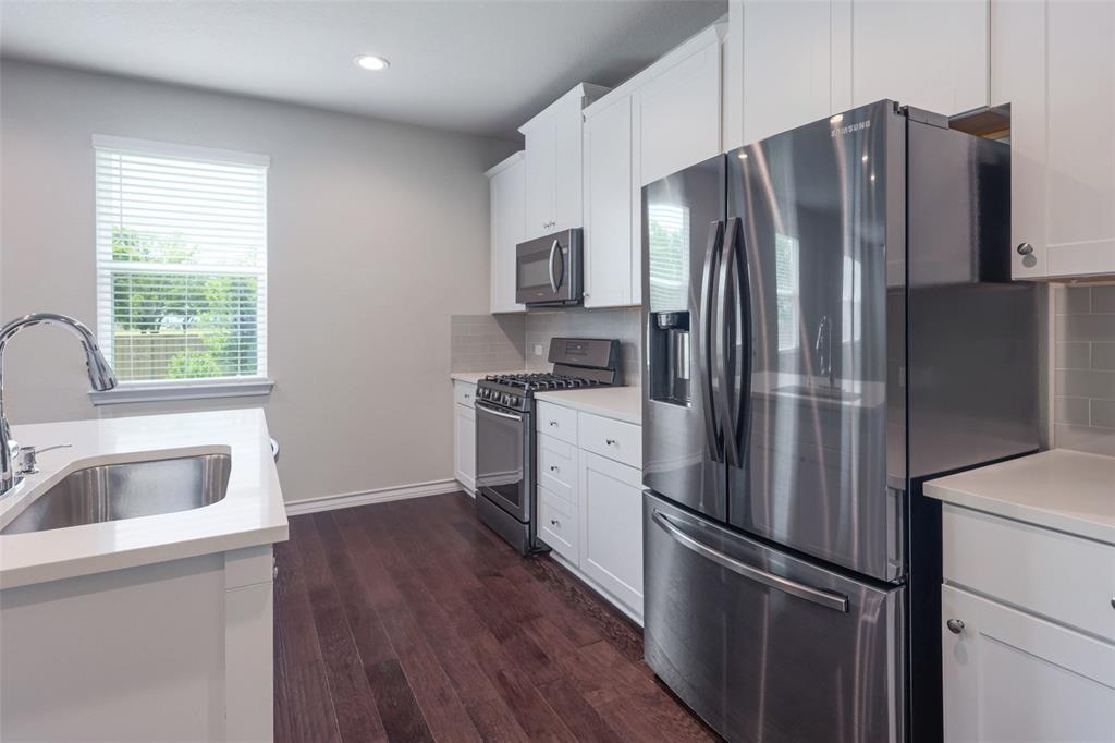 2004 Rinker Ranch Drive Austin, TX 78725 - Photo 4 of 23 a kitchen with stainless steel appliances a refrigerator sink and microwave