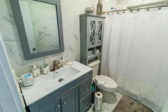 a bathroom with a sink toilet and shower