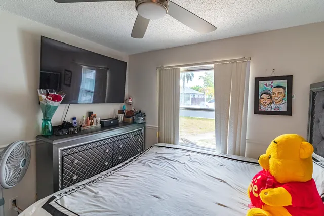 a bedroom with furniture and a large window