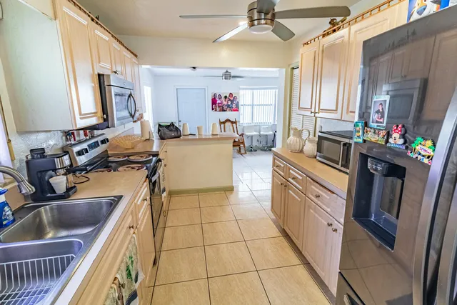 a kitchen with a sink appliances and cabinets