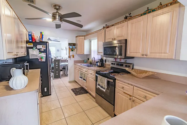 a kitchen with stainless steel appliances granite countertop a stove sink and cabinets