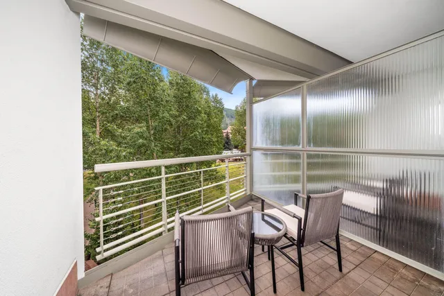 a view of a chair and table in the balcony
