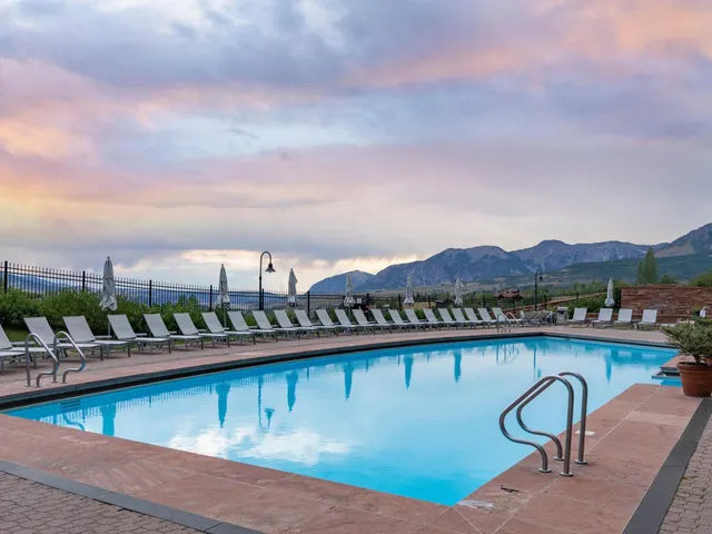a view of swimming pool with outdoor seating and lake view
