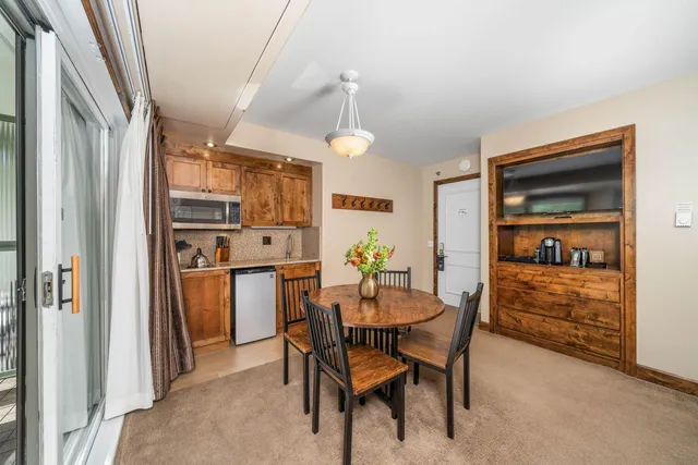 a dining room with furniture and window