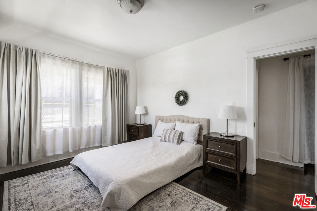 1120 West Edgeware Road Los Angeles, CA 90026 - Photo 12 of 32 a bedroom with a bed and wooden floor
