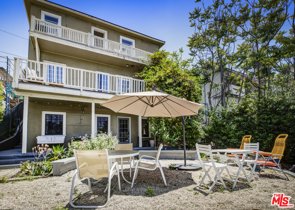 1120 West Edgeware Road Los Angeles, CA 90026 - Photo 2 of 32 a view of a patio with a table and chairs under an umbrella