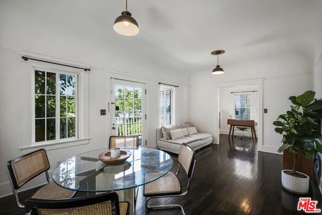 a dining room with furniture window and wooden floor