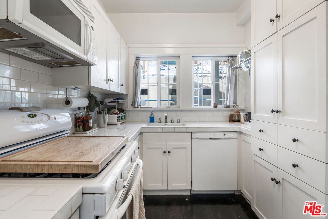 1120 West Edgeware Road Los Angeles, CA 90026 - Photo 23 of 32 a kitchen with a sink a stove and cabinets