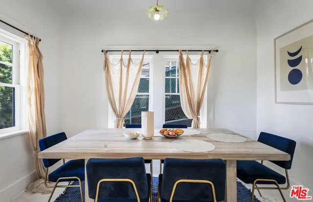 a view of a dining room with furniture and window