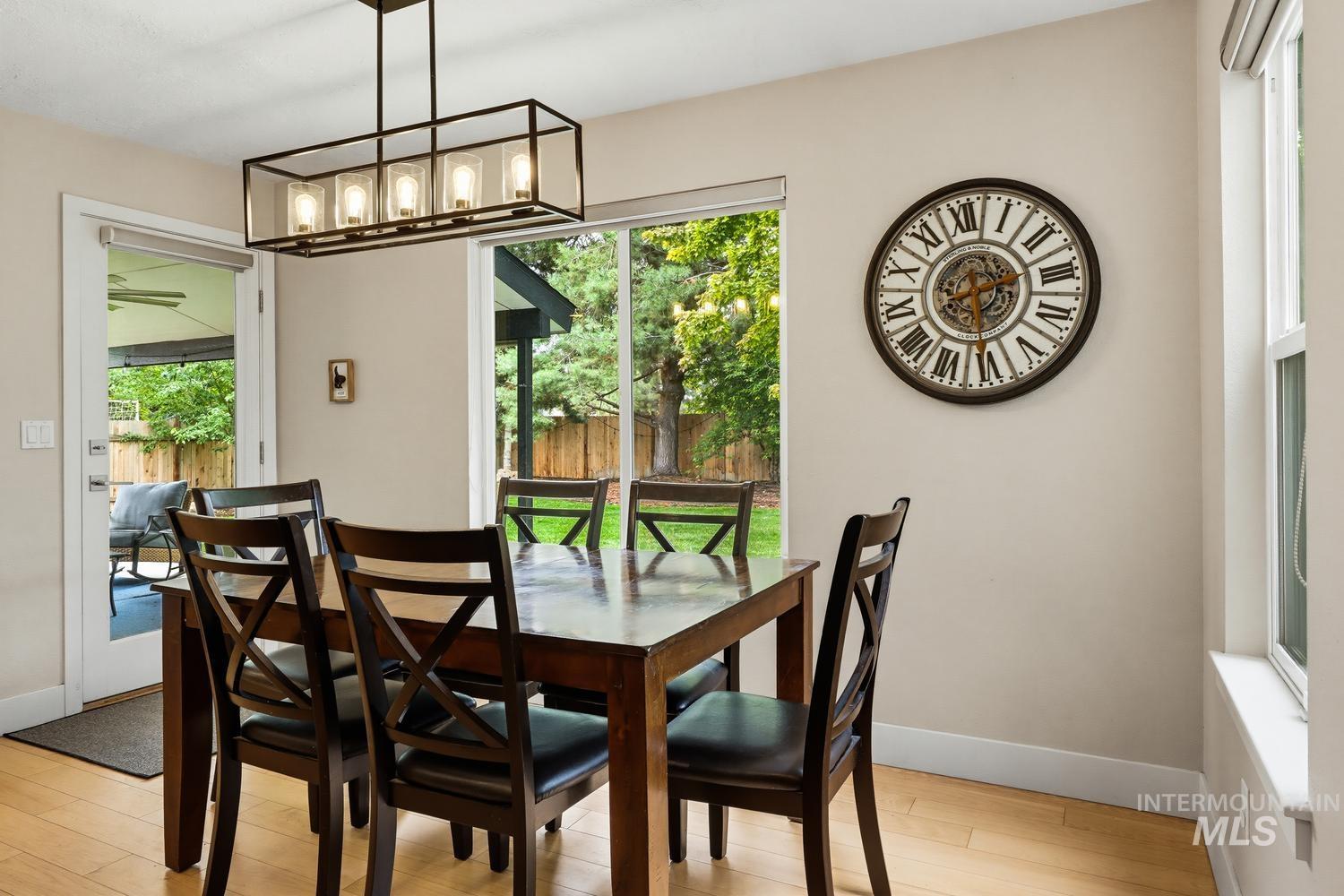 369 South Winthrop Way Boise, ID 83709 - Photo 18 of 50 Dining area featuring wood-finish flooring and a rectangular linear chandelier