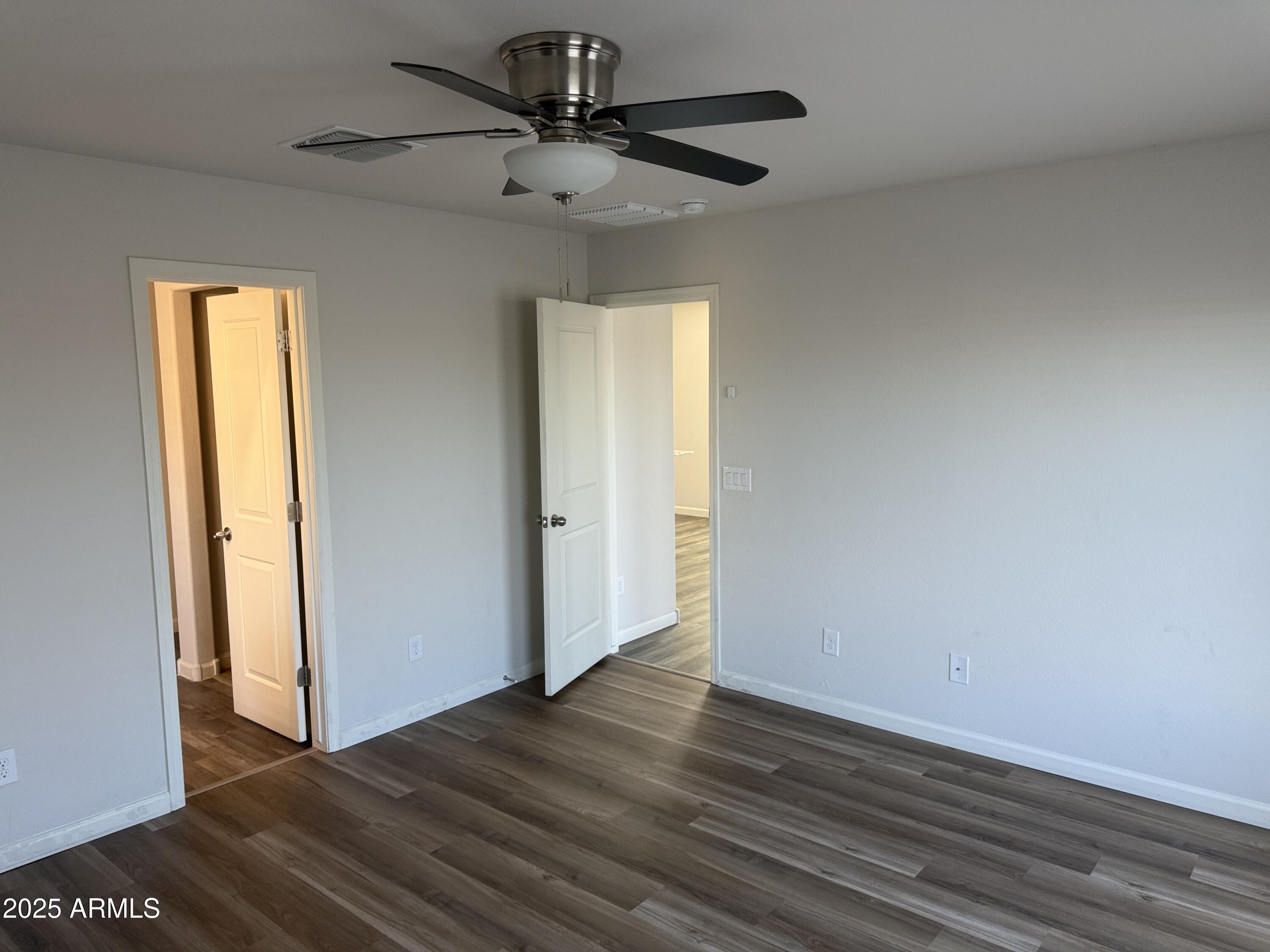 1098 South 11th Street Coolidge, AZ 85128 - Photo 14 of 20 a view of a big room with wooden floor and chandelier fan