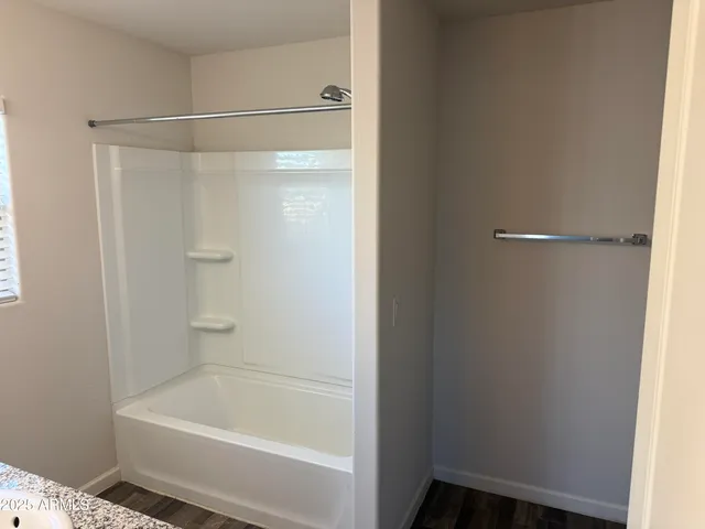 a bathroom with a shower and a bath tub