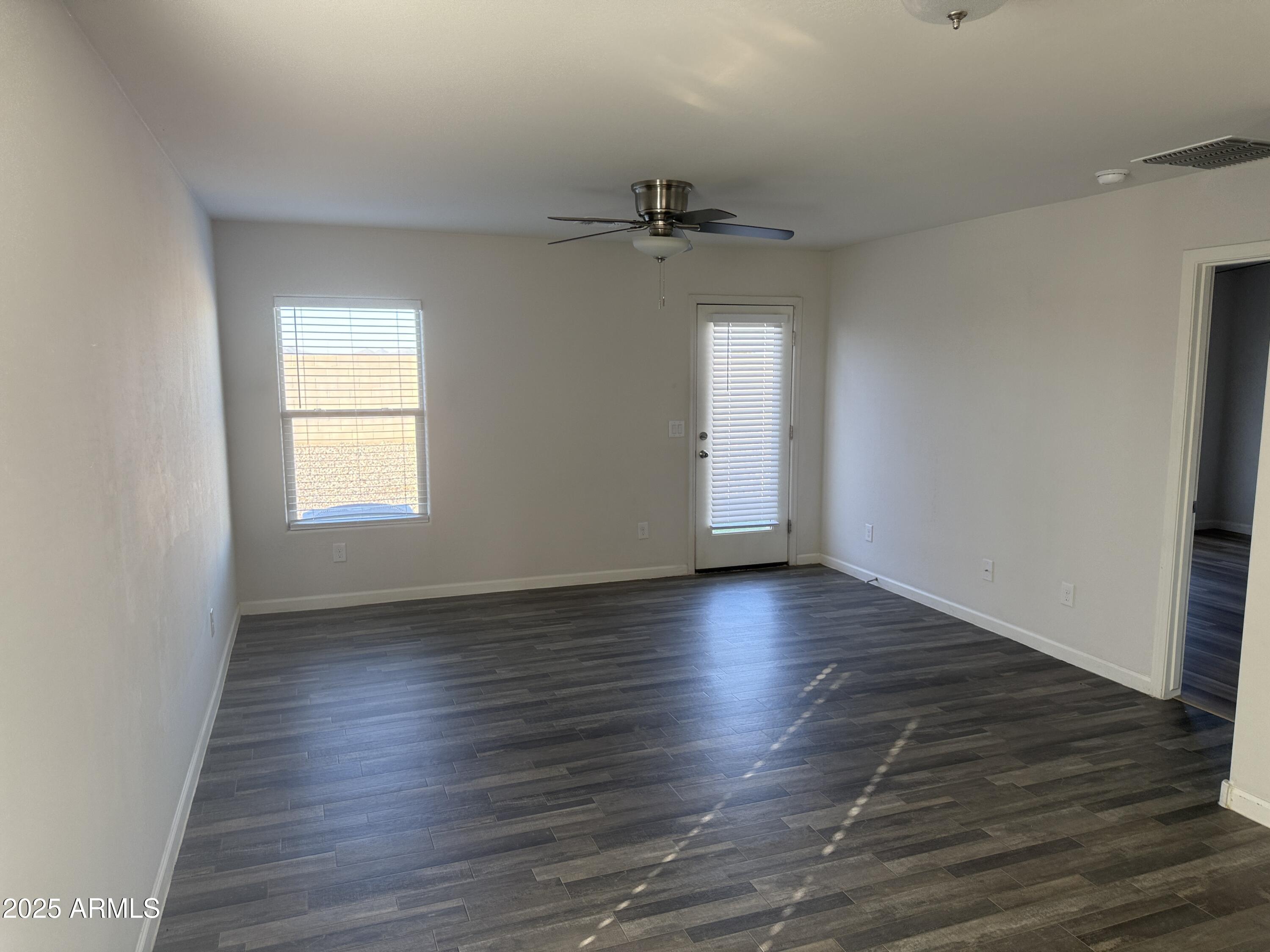 1098 South 11th Street Coolidge, AZ 85128 - Photo 9 of 20 an empty room with wooden floor and windows