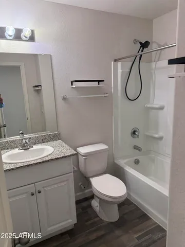 a bathroom with a granite countertop toilet sink and a bathtub