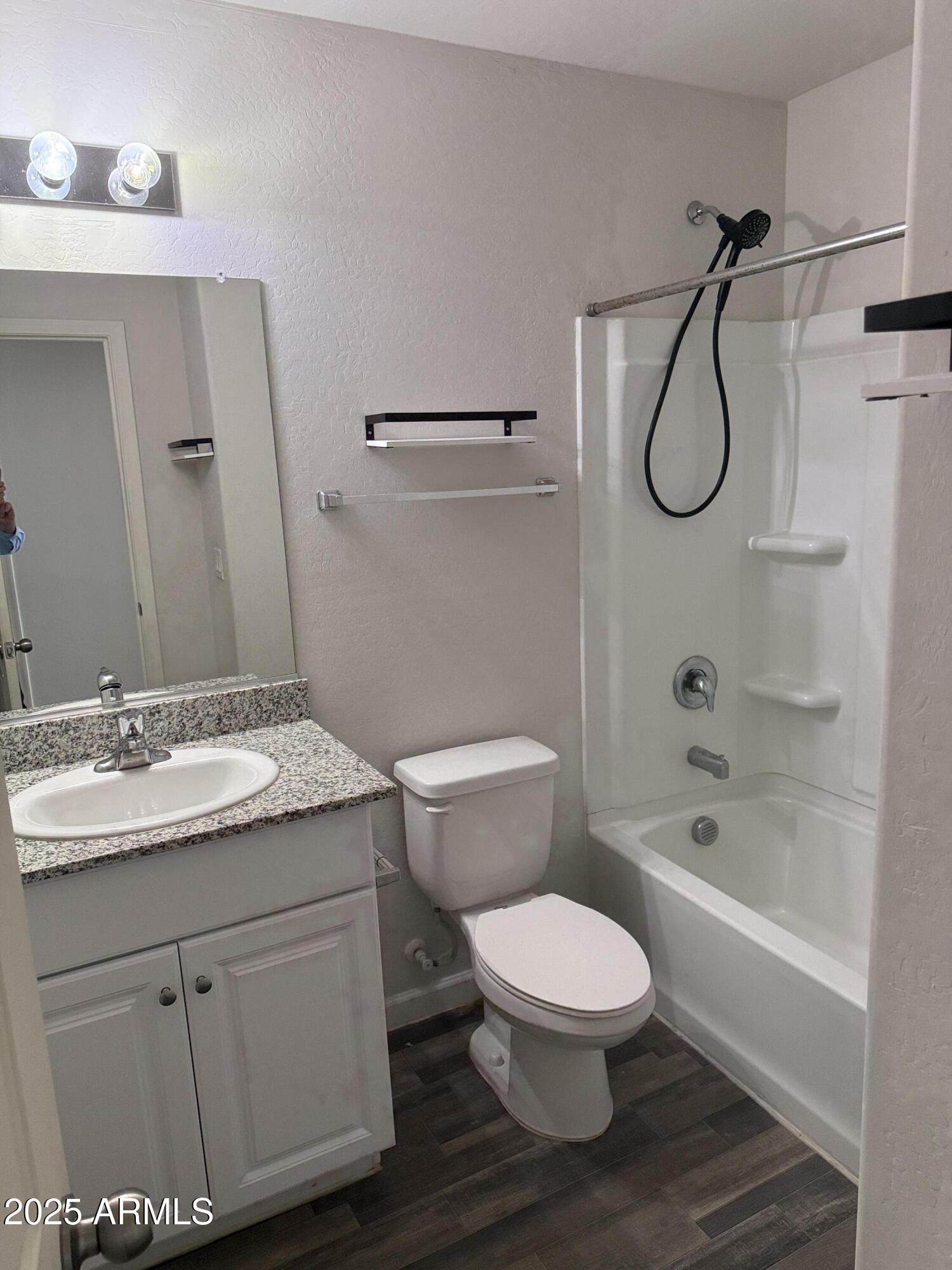 1098 South 11th Street Coolidge, AZ 85128 - Photo 10 of 20 a bathroom with a granite countertop toilet sink and a bathtub