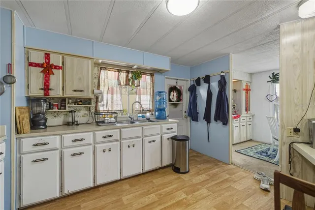 a kitchen with cabinets and window