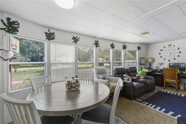 a living room with fireplace furniture and a large window