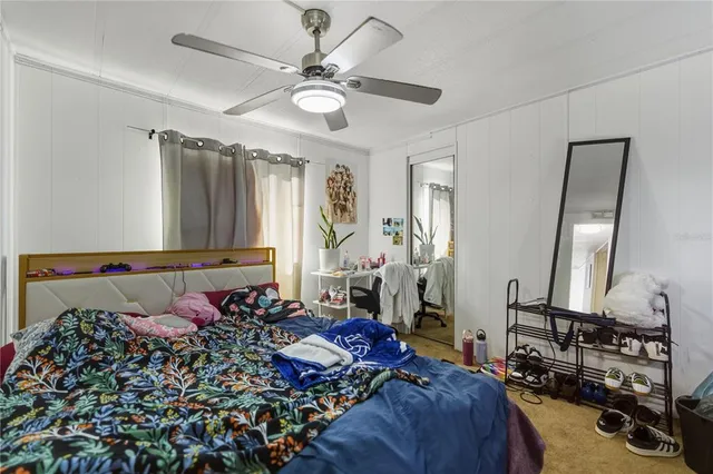 a bed room with a bed mirror and a window