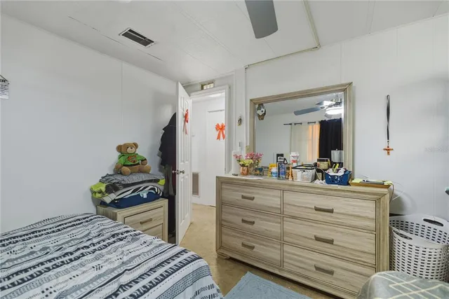 a bedroom with a bed and a dresser in it