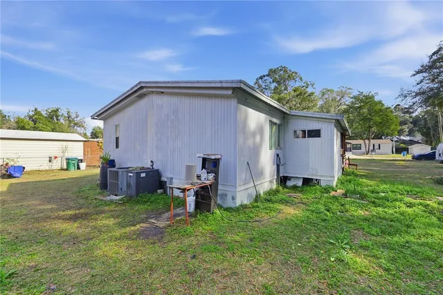 a backyard of a house with table and chairs