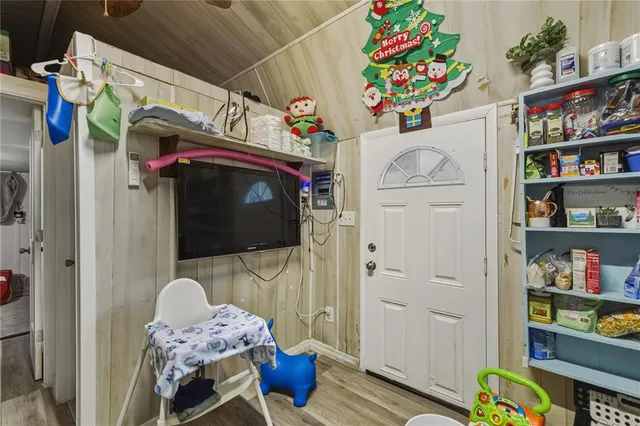 a utility room with painting and wooden floor