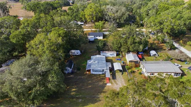 an aerial view of a house with a yard and lake view