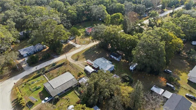 an aerial view of a house with a yard