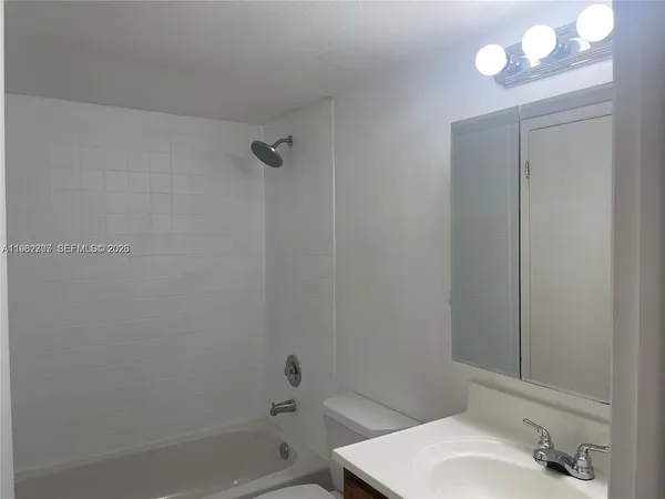 a bathroom with a sink and shower