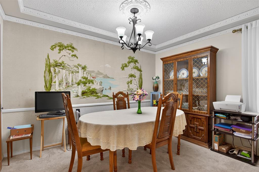 6010 Hunters View Lane Dallas, TX 75232 - Photo 8 of 28 Dining area featuring a decorative wall mural, crown molding, and a central chandelier