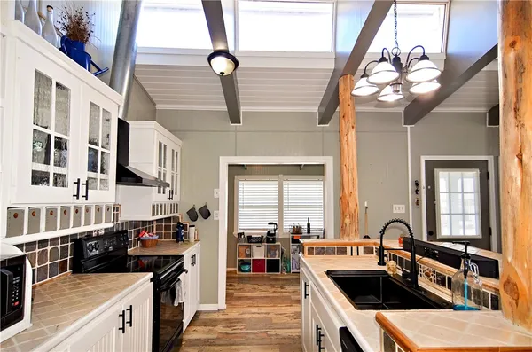 a kitchen with a sink appliances and cabinets