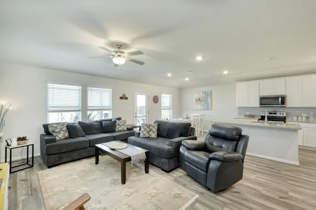 a living room with furniture and a large window