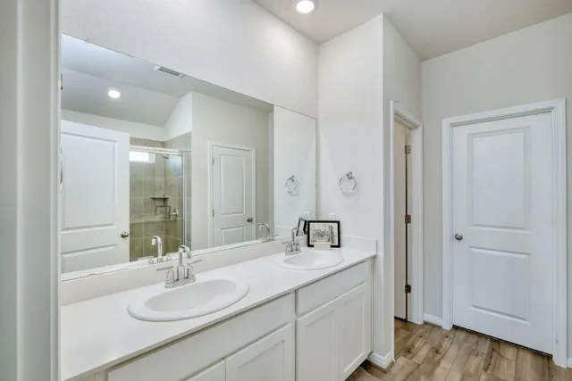 a bathroom with a sink double vanity and a mirror