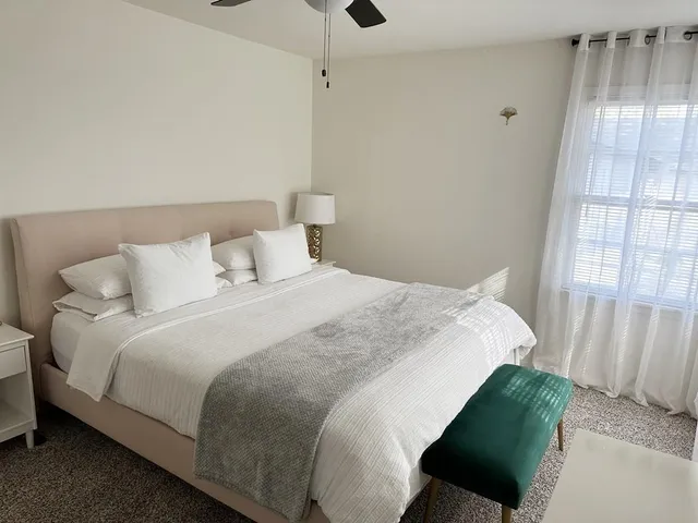 a bedroom with a bed and a window