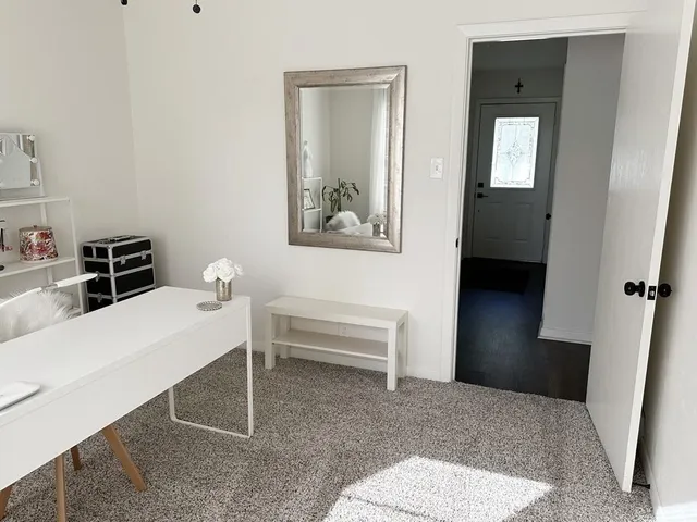 a bedroom with a bed and a table in it