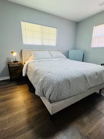 a bedroom with a bed and window