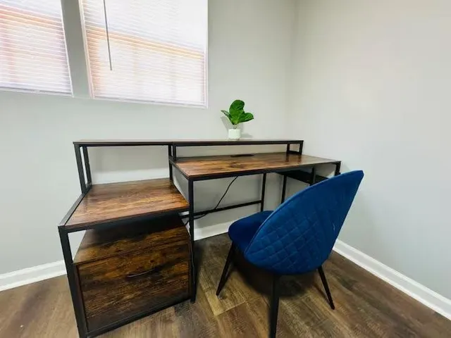 a room with table chair and a window